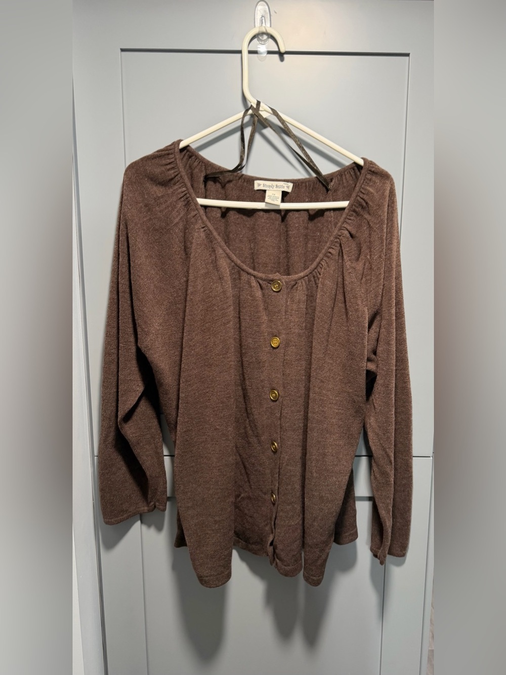 This brown, textured button-up long-sleeve sweater is  the brand Simply Suzie.